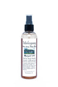 Bottle of Mahogany Royal Oil with a spray nozzle on a white background