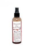 Bottle of Cinnamon Clove body spray with a white label on a white background