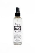 Clear bottle of Pikake Royal Oil with black cap on a white background