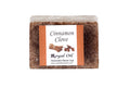 Bar of cinnamon clove soap with a label on a white background