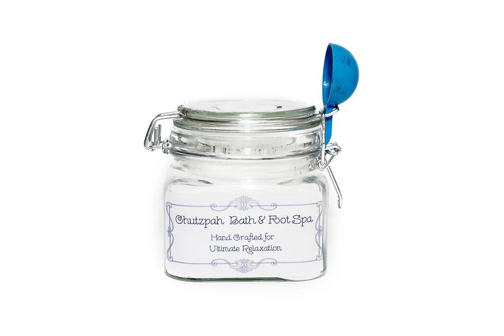 Glass jar with a blue scoop on a white background
